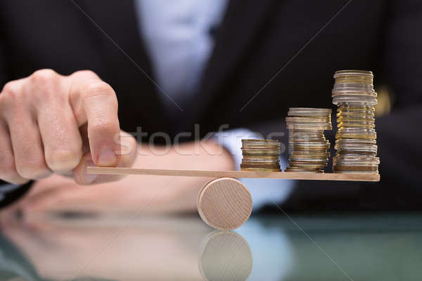 üzletember egyensúlyoz egymásra pakolva érmék hinta közelkép Stock fotó © AndreyPopov