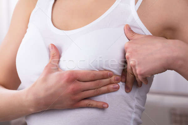 Close-up Of A Woman's Hand On Breast Stock photo © AndreyPopov