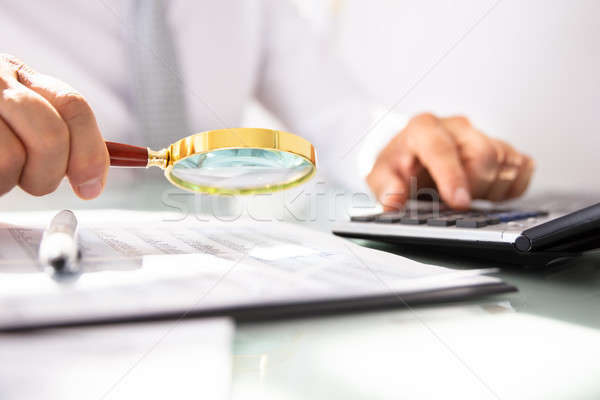 üzletember pénzügyi beszámoló nagyító kéz számológép férfi Stock fotó © AndreyPopov