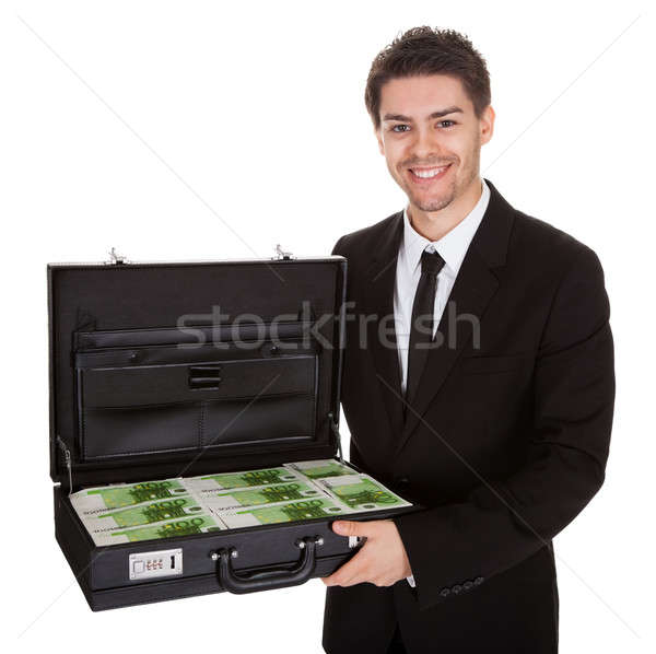 Businessman with suitcase full of cash Stock photo © AndreyPopov