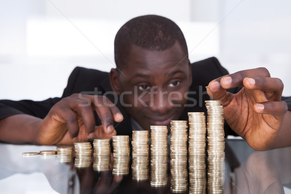 Businessman Stacking Coins In A Row Stock photo © AndreyPopov
