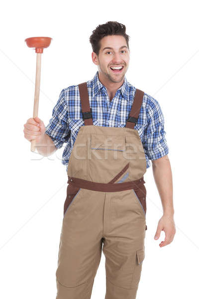 Excited Young Male Plumber Holding Plunger Stock photo © AndreyPopov
