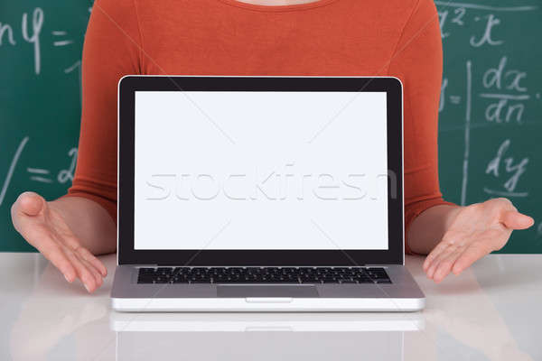 Stock photo: Student Displaying Laptop With Blank Screen In Classroom