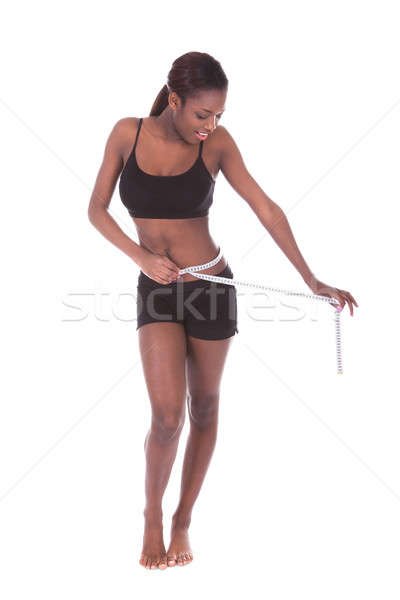 Woman in undergarments measuring waist with tape Stock photo © AndreyPopov