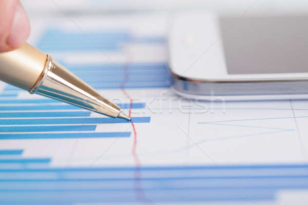 Stock photo: Businessman Analyzing Bargraph At Desk