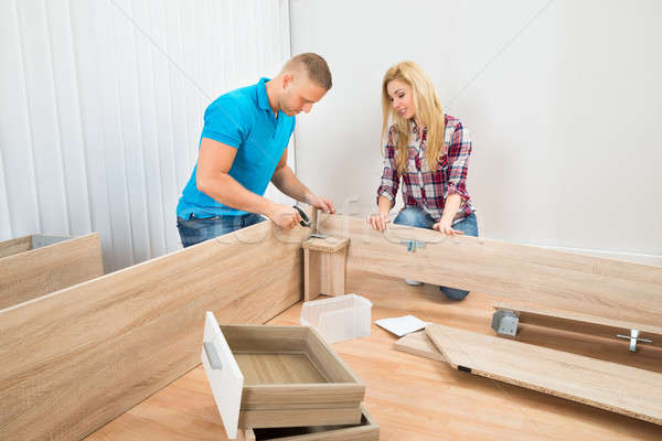 Couple Assembling Wooden Furniture Stock photo © AndreyPopov
