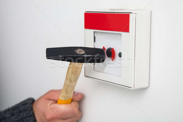 Person Breaking Glass Of Emergency Button Stock photo © AndreyPopov