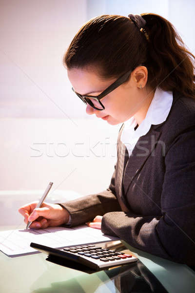 Stock photo: Businesswoman Calculating Tax