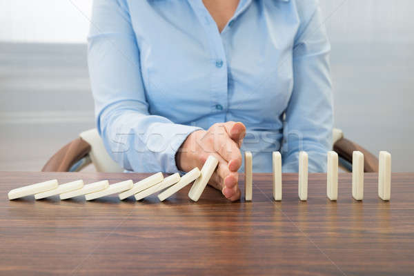 Businesswoman Stopping The Effect Of Domino Stock photo © AndreyPopov