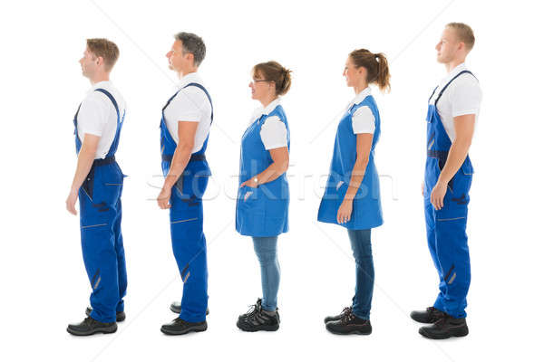 Side View Of Janitors Standing In Queue Stock photo © AndreyPopov