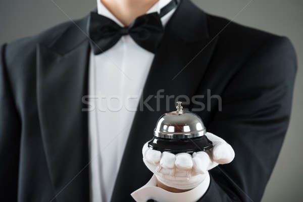 Midsection Of Waiter Holding Service Bell Stock photo © AndreyPopov