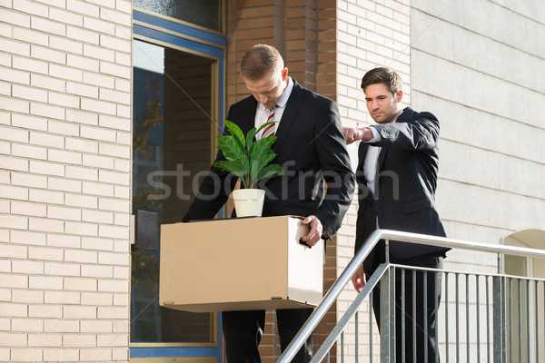 Businessman Firing Employee Outside Office Stock photo © AndreyPopov