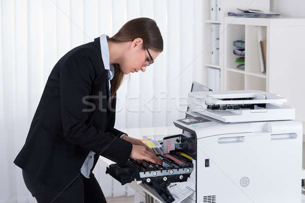 Businesswoman Fixing Copy Machine Stock photo © AndreyPopov