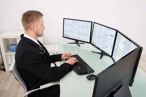 Businessman Looking At Graph On Computer Screen Stock photo © AndreyPopov