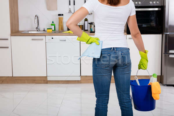 Woman Holding Cleaning Tools And Products In Bucket Stock photo © AndreyPopov