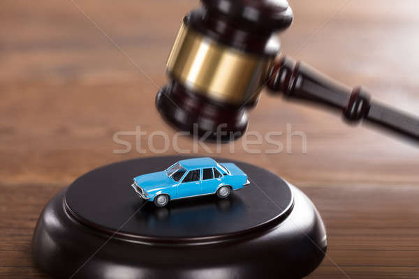 Gavel Striking On A Car Model Stock photo © AndreyPopov