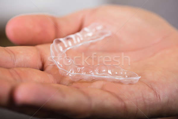 Person's Palm With Transparent Aligner Stock photo © AndreyPopov