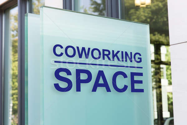 Coworking space sign on glass board outside building in city Stock photo © AndreyPopov