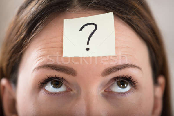 Businesswoman's Forehead With Question Mark On Sticky Note Stock photo © AndreyPopov