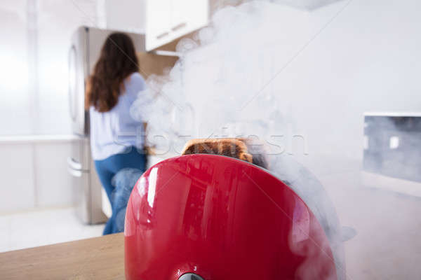 Smoke Emitting Through Burnt Toast Coming Out From Toaster Stock photo © AndreyPopov