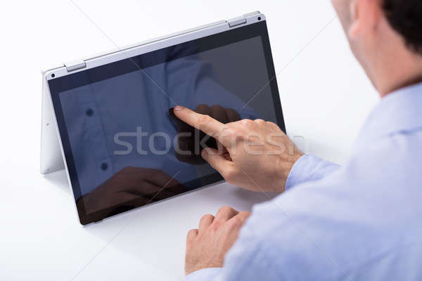Man Touching Hybrid Laptop Screen With Finger Stock photo © AndreyPopov