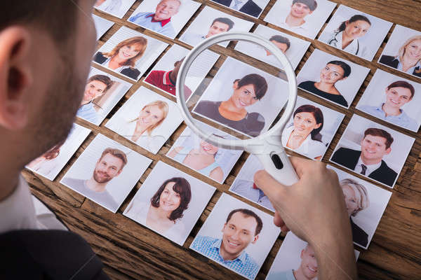 Looking At Candidate's Photograph With Magnifying Glass Stock photo © AndreyPopov