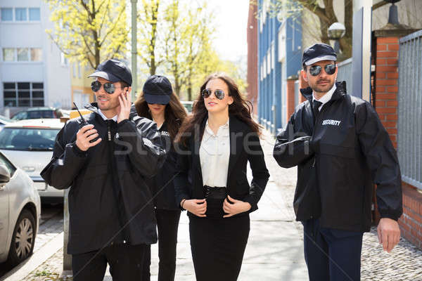 Stock photo: Portrait Of Female Celebrity With Bodyguards