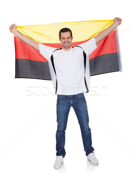 Stock photo: Portrait Of A Happy Man Holding An German Flag