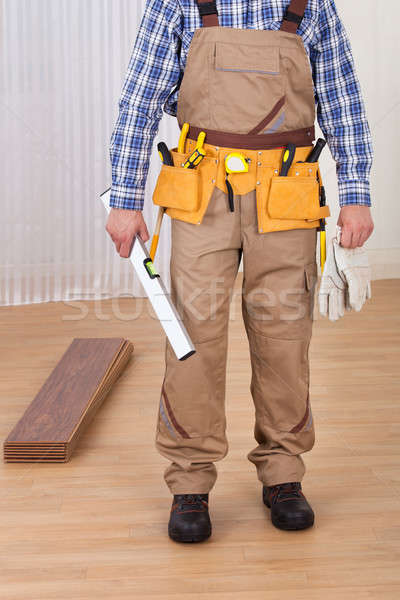 Carpenter With Spirit Level And Gloves Stock photo © AndreyPopov