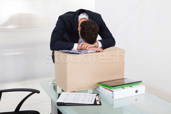 Tired Businessman Resting On Cardboard Box At Desk Stock photo © AndreyPopov