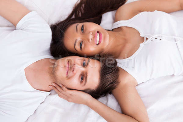 Young Couple Lying On Mattress Stock photo © AndreyPopov