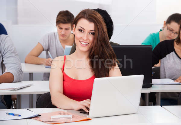 Gyönyörű egyetemi hallgató laptop asztal portré ül Stock fotó © AndreyPopov