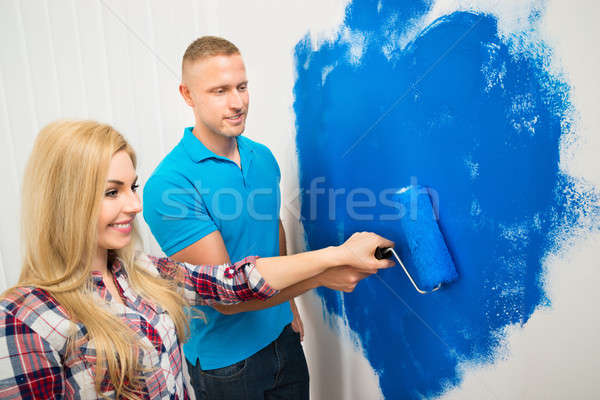 Young Couple Painting Wall Stock photo © AndreyPopov