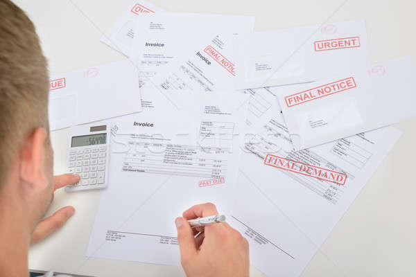 Man Calculating Invoices Stock photo © AndreyPopov