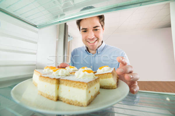 Man Taking Cake View From Inside The Refrigerator Stock photo © AndreyPopov