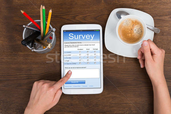 Stock photo: Person Filling Survey Form On Mobile Phone