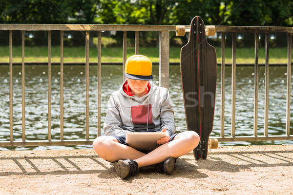 Boy Wearing Cap Using Digital Tablet Stock photo © AndreyPopov