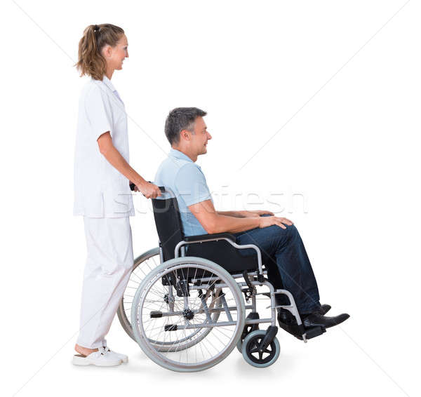 Poussant handicapées patient fauteuil roulant Homme Homme Photo stock © AndreyPopov
