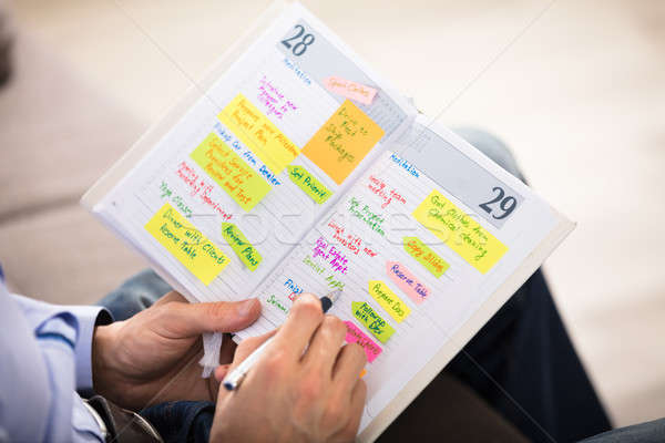 Stock photo: Man Writing Important Notes In Diary