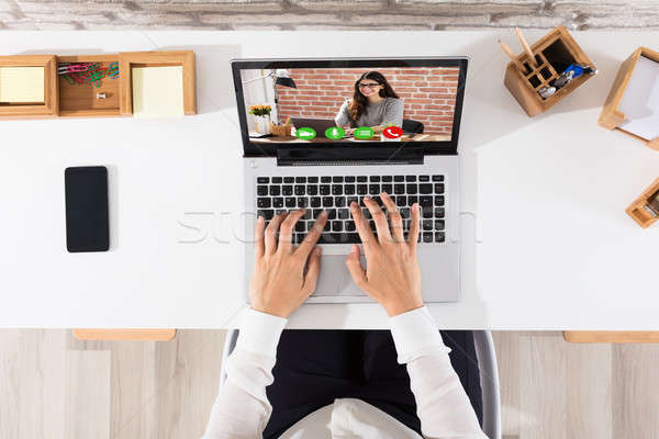 Elevated View Of Businessperson Videoconferencing On Laptop Stock photo © AndreyPopov