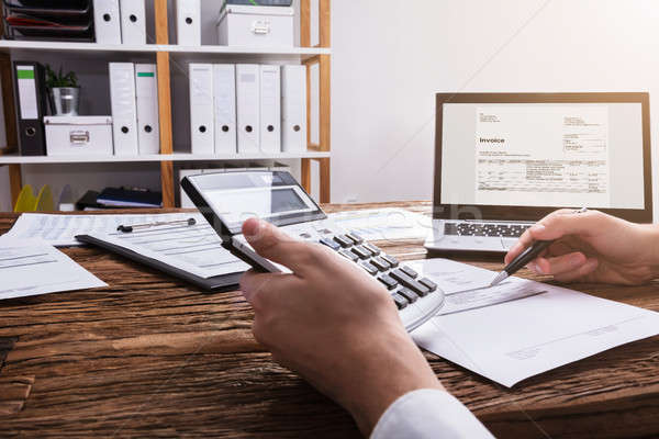 Businessperson's Hand Calculating Bill With Calculator Stock photo © AndreyPopov