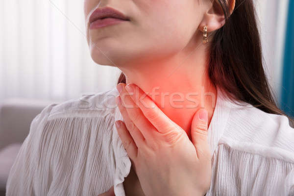 Donna sofferenza mal di gola primo piano mano toccare Foto d'archivio © AndreyPopov