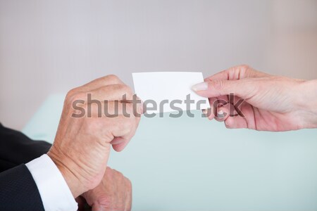 Stock photo: Businesspeople Exchanging Visiting Card In Office