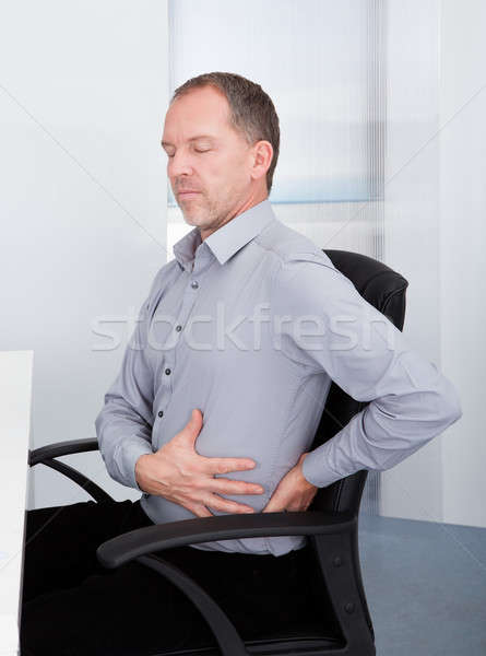 Businessman Suffering From Back Pain Stock photo © AndreyPopov