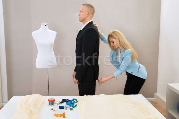 Női szabó elvesz mérés öltöny férfi Stock fotó © AndreyPopov