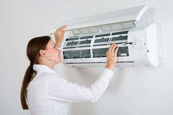 Businesswoman Checking Air Conditioner Stock photo © AndreyPopov