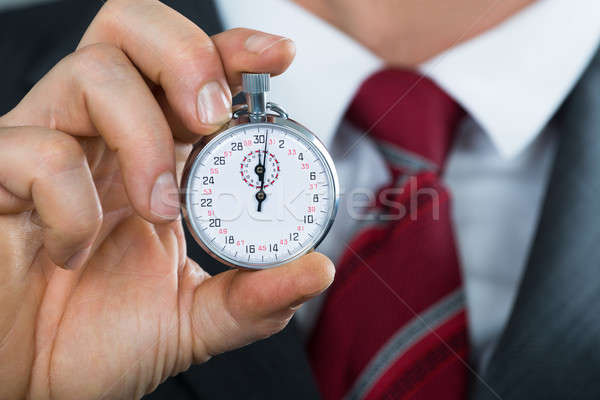 Close-up Of Businessman Hand Holding Stop Watch Stock photo © AndreyPopov