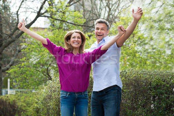 Stock photo: Happy Couple Raising Hands