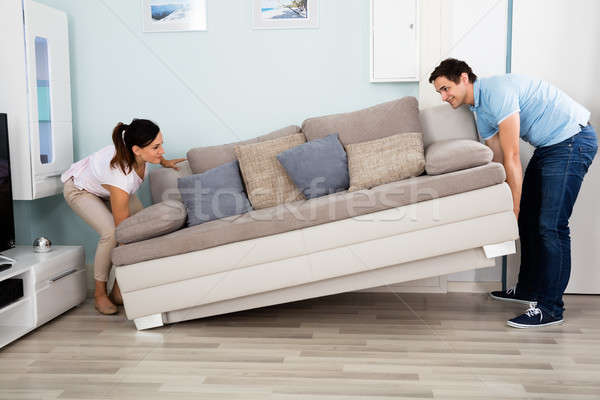 Couple Placing Sofa In Living Room Stock photo © AndreyPopov