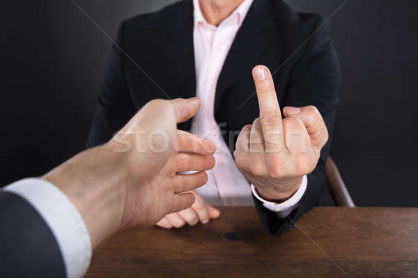 Businessman Showing Middle Finger To A Partner Stock photo © AndreyPopov